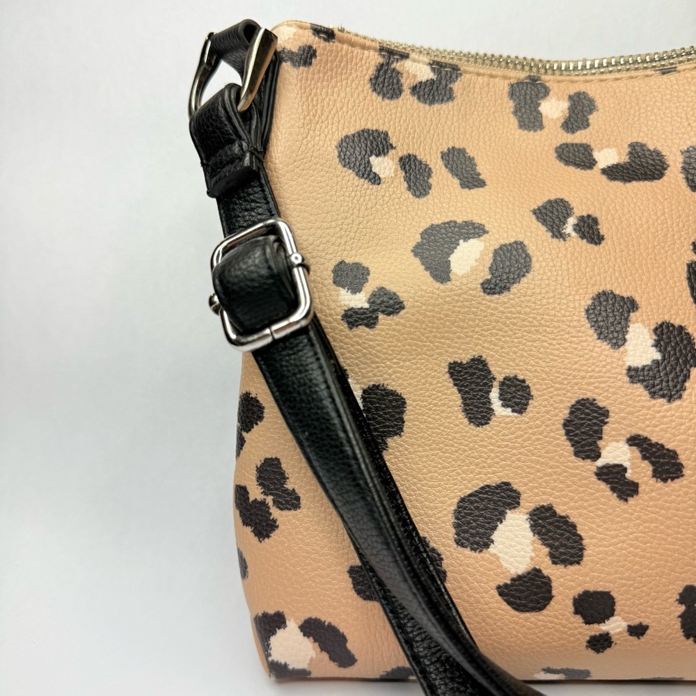 Cheetah Print Tan and black faux leather crossbody bag with adjustable strap.